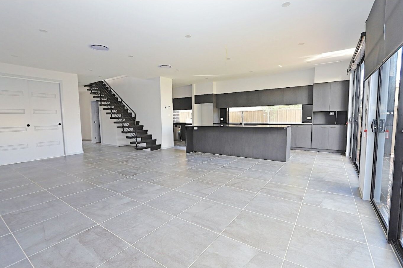 Open-plan living, dining and kitchen at 1/82 Doonmore Street