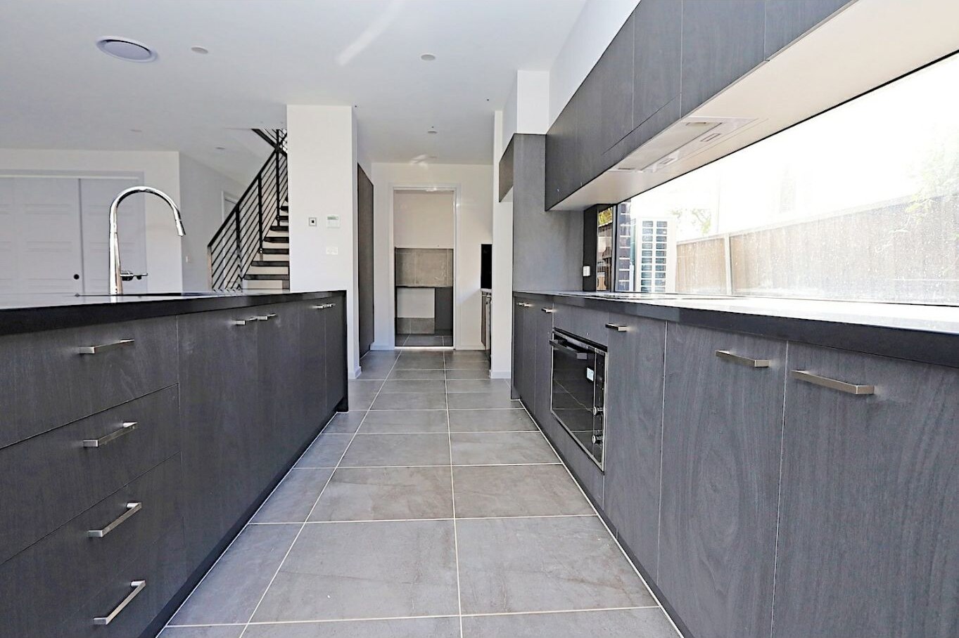 Stone kitchen with island bench and 900 millimetre appliances