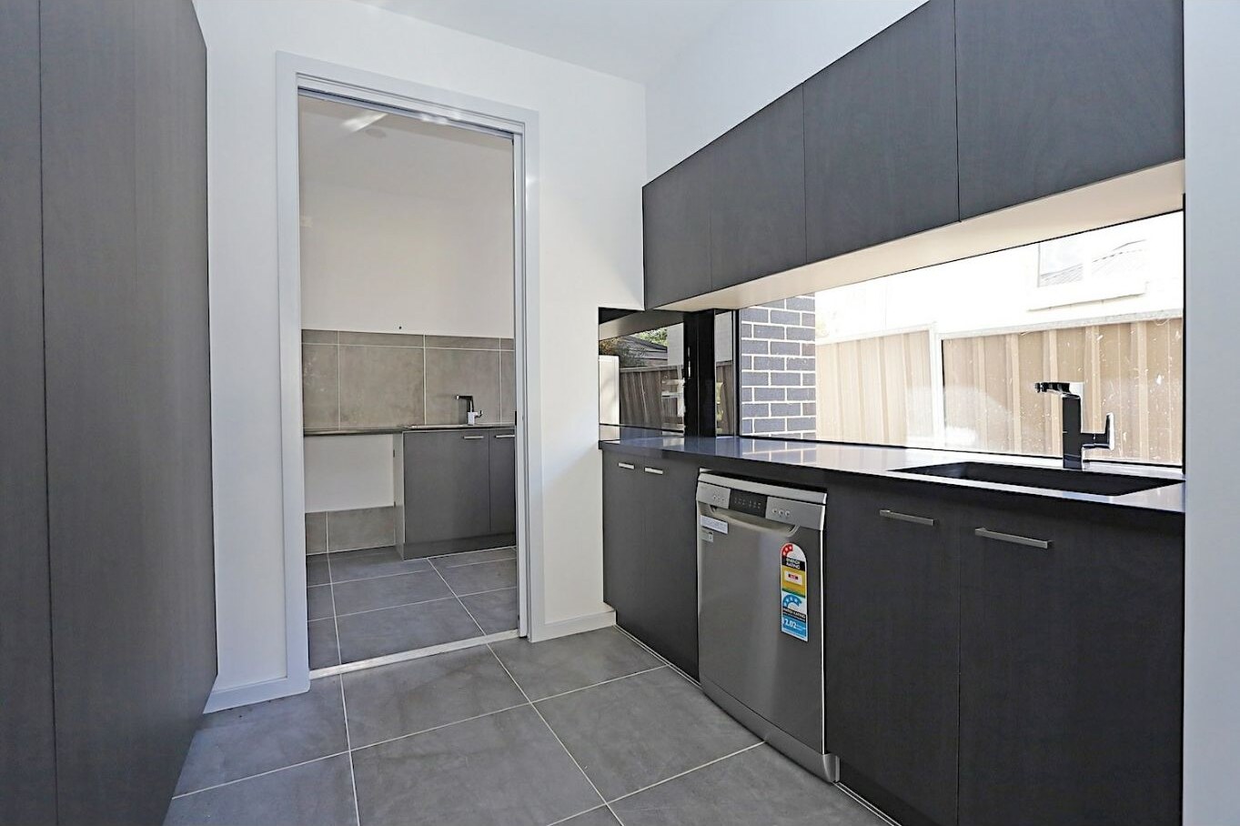 Butler's pantry with dishwasher and storage